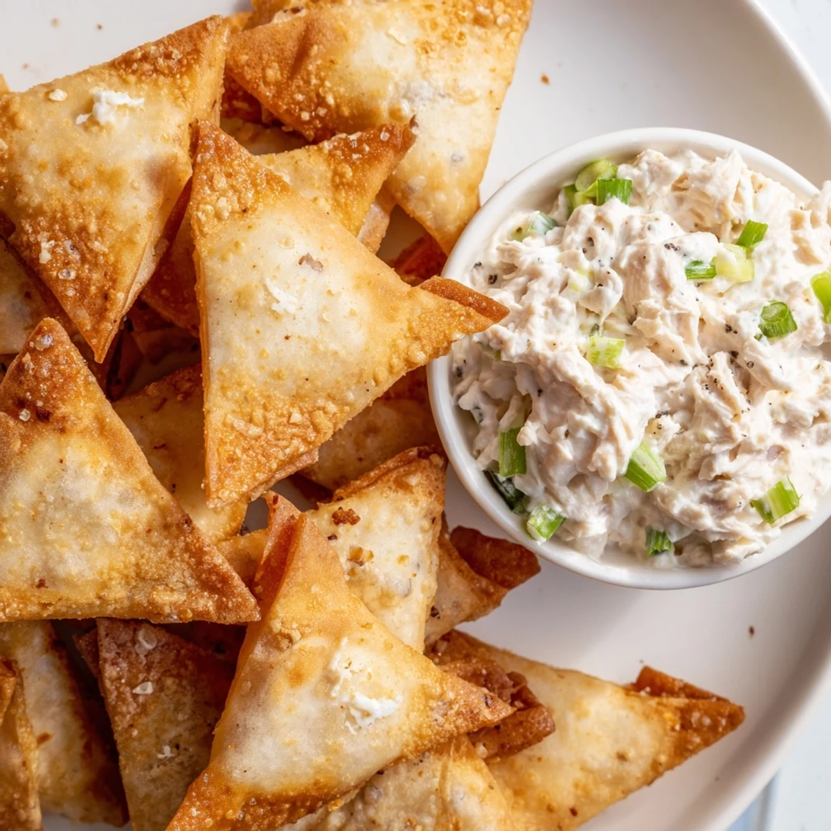 Freshly made air fryer lumpia chips, ready to be dipped into the flavorful, homemade chicken cream cheese.