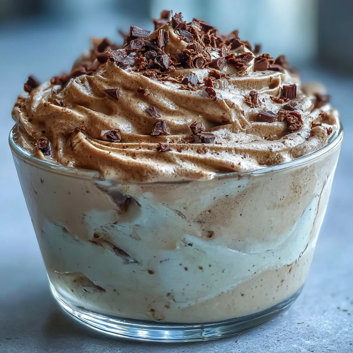 Delicate roasted tea mousse garnished with cocoa nibs, ready to serve.