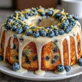 Lemon Blueberry Spring Birthday Cake with fresh blueberries and lemon zest curls on top, perfect for spring celebrations.