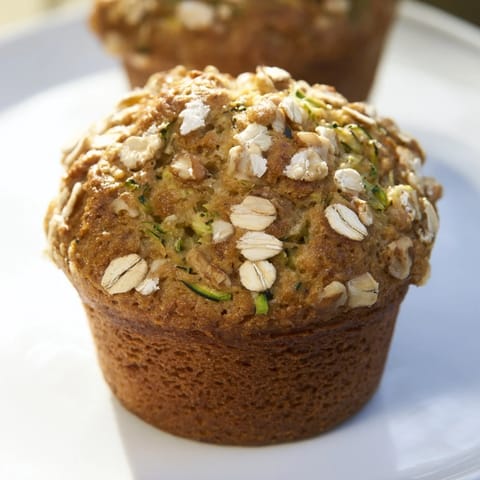 A stack of freshly baked freezer-friendly breakfast muffins, slightly domed and ready to enjoy.