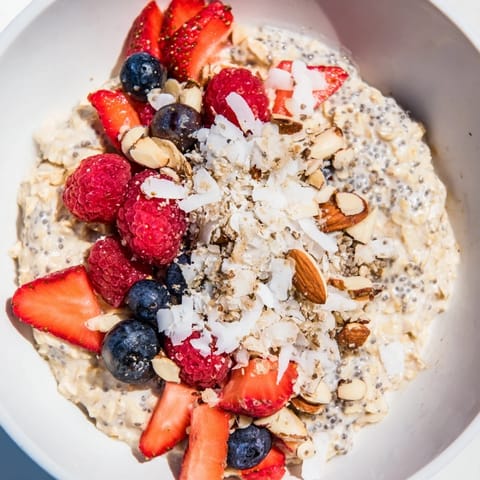A close-up of Overnight Oats with Berries, showcasing the creamy texture and sweet, red strawberries.