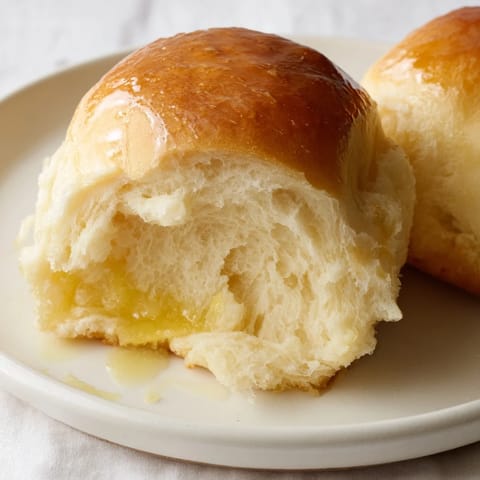 These soft, pillowy Homemade Golden Dinner Rolls are beautifully browned and ready to bring to the table.