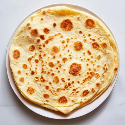 Picture warm, slightly puffed Three-Ingredient Easy Flatbreads, perfect for scooping up delicious hummus.