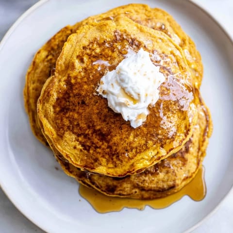 Warm and comforting image of fluffy pumpkin spice pancakes, ideal for a delicious breakfast this fall.