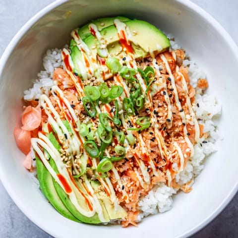 Vibrant Classic Salmon Rice bowl, featuring creamy avocado and savory toppings, ready to enjoy.