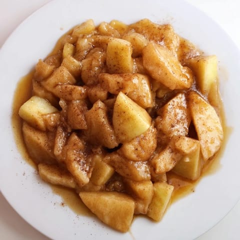 Golden slow cooker stewed apples brimming with honey and cinnamon; ideal breakfast topping.