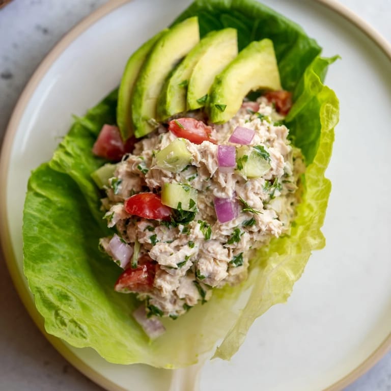 Close-up of healthy Tuna Salad Lettuce Wraps, featuring avocado and tomato alongside the flavorful tuna.