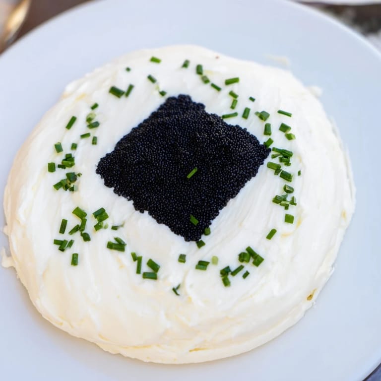 The Diamond Inlay appetizer featuring a stunning black caviar or tapenade diamond on a bed of cream cheese.