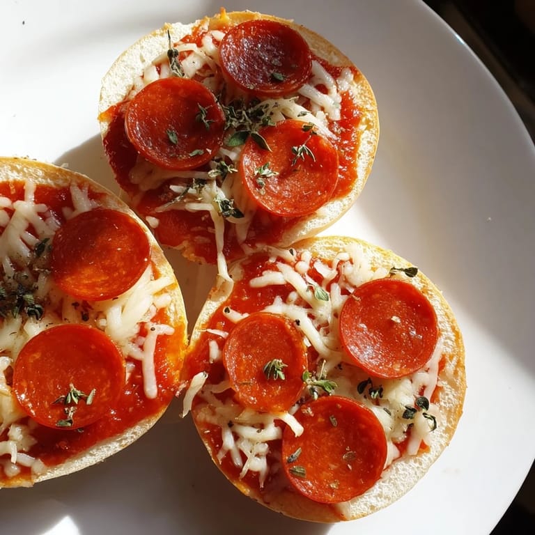 Golden-brown mini pepperoni pizza bagels, fresh from the oven, offering a delightful cheesy aroma.