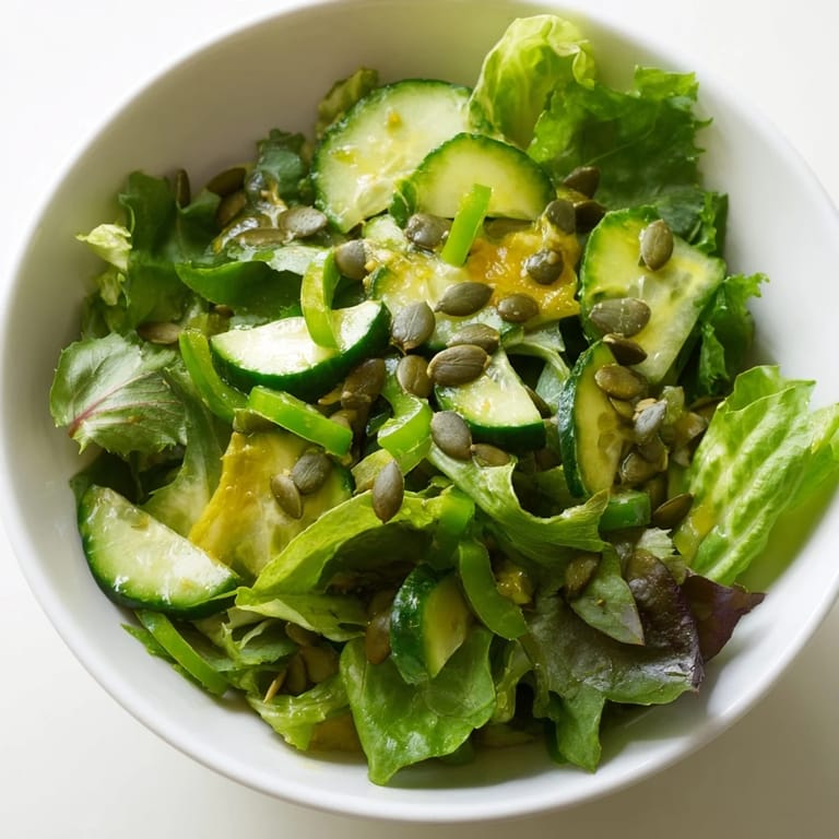 Healthy vegan Glowing Green Salad served in a white bowl, perfect as a light side dish with bright, refreshing flavors.